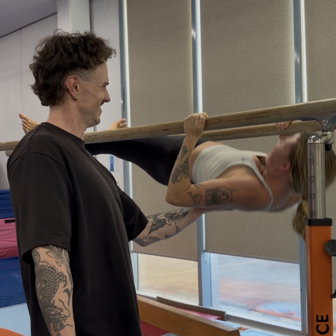 Adrian coaching gymnastics